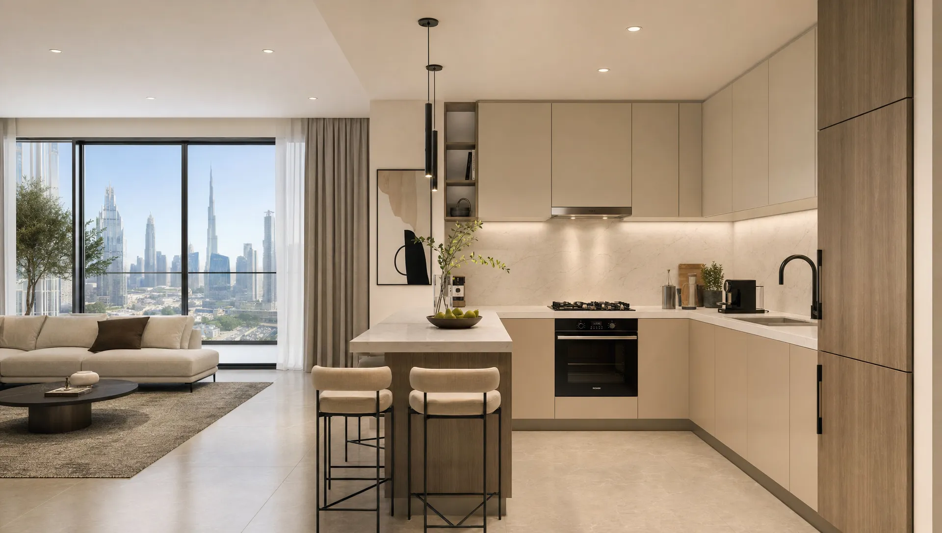A modern Dubai kitchen with an L-shaped layout, integrated appliances, and a compact island with seating beside the living area.