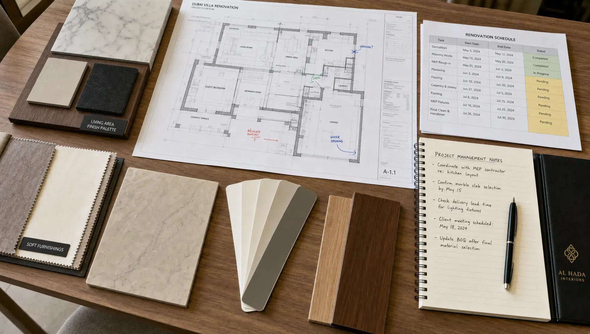 A Dubai villa renovation table holds material samples, a printed schedule, marked floor plans, and management notes.